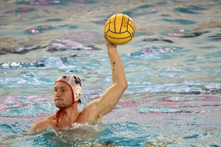 Declan麦克吉尔顿 prepares to throw the ball while playing water polo