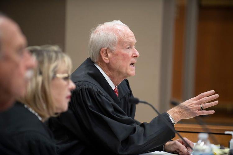 A judge makes a hand gesture